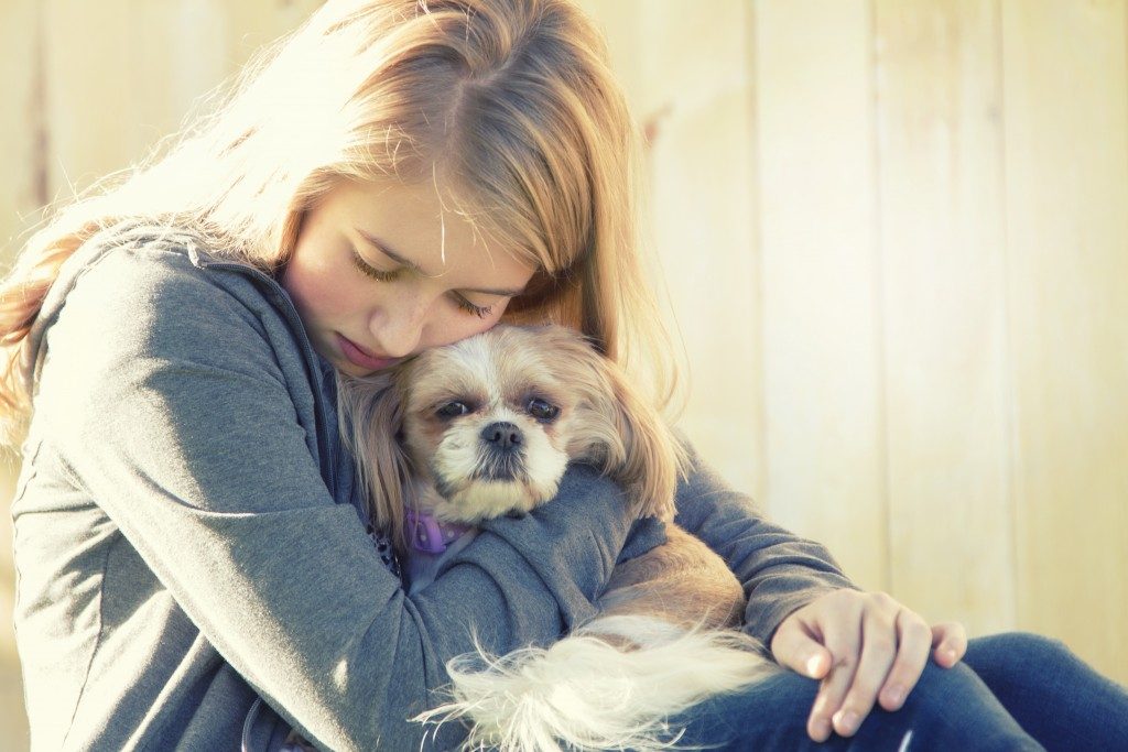girl hugging her dog